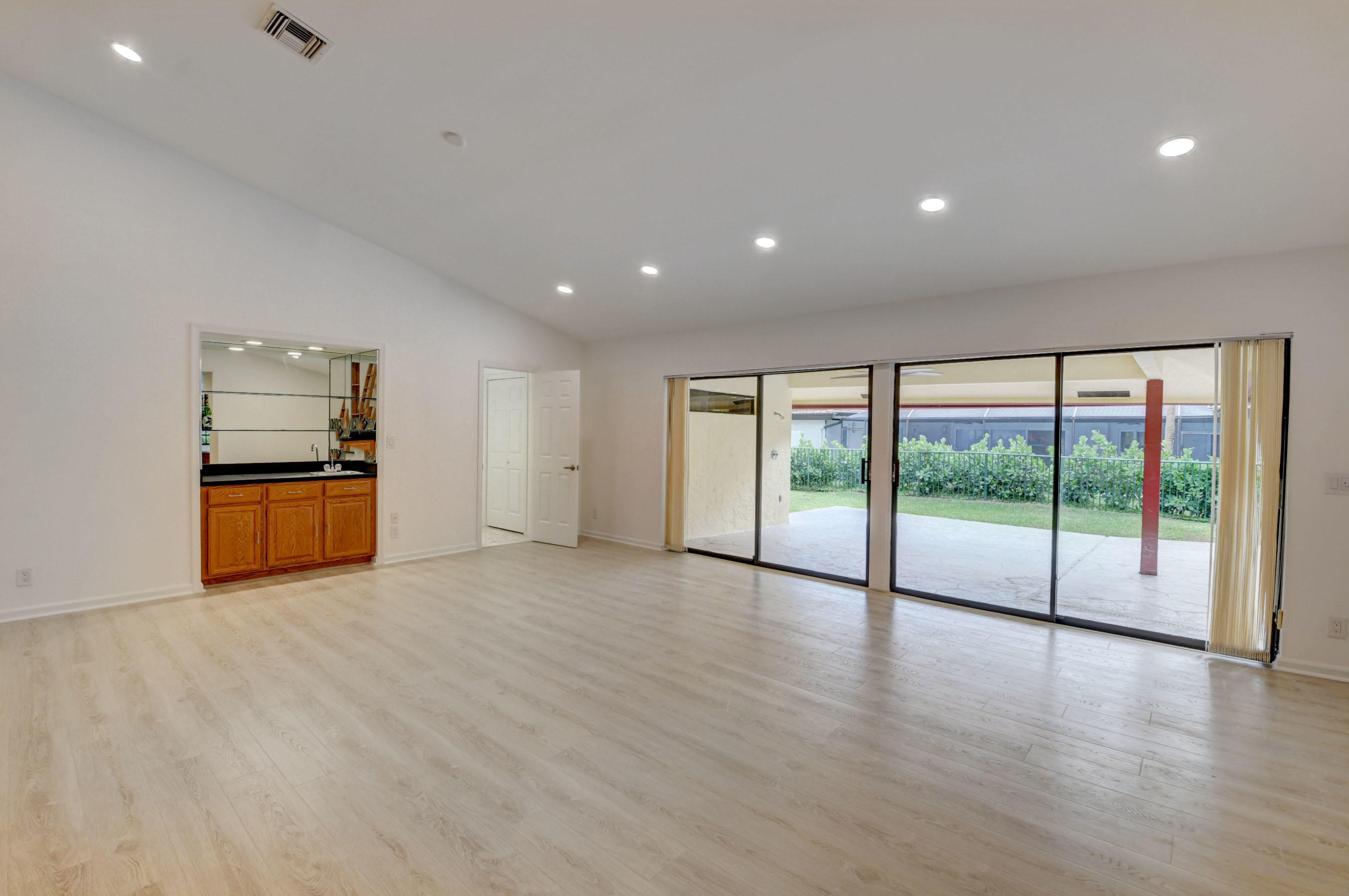 3230 St James Drive Boca Raton, FL 33434 - Photo 12 of 62 a view of an empty room with wooden floor