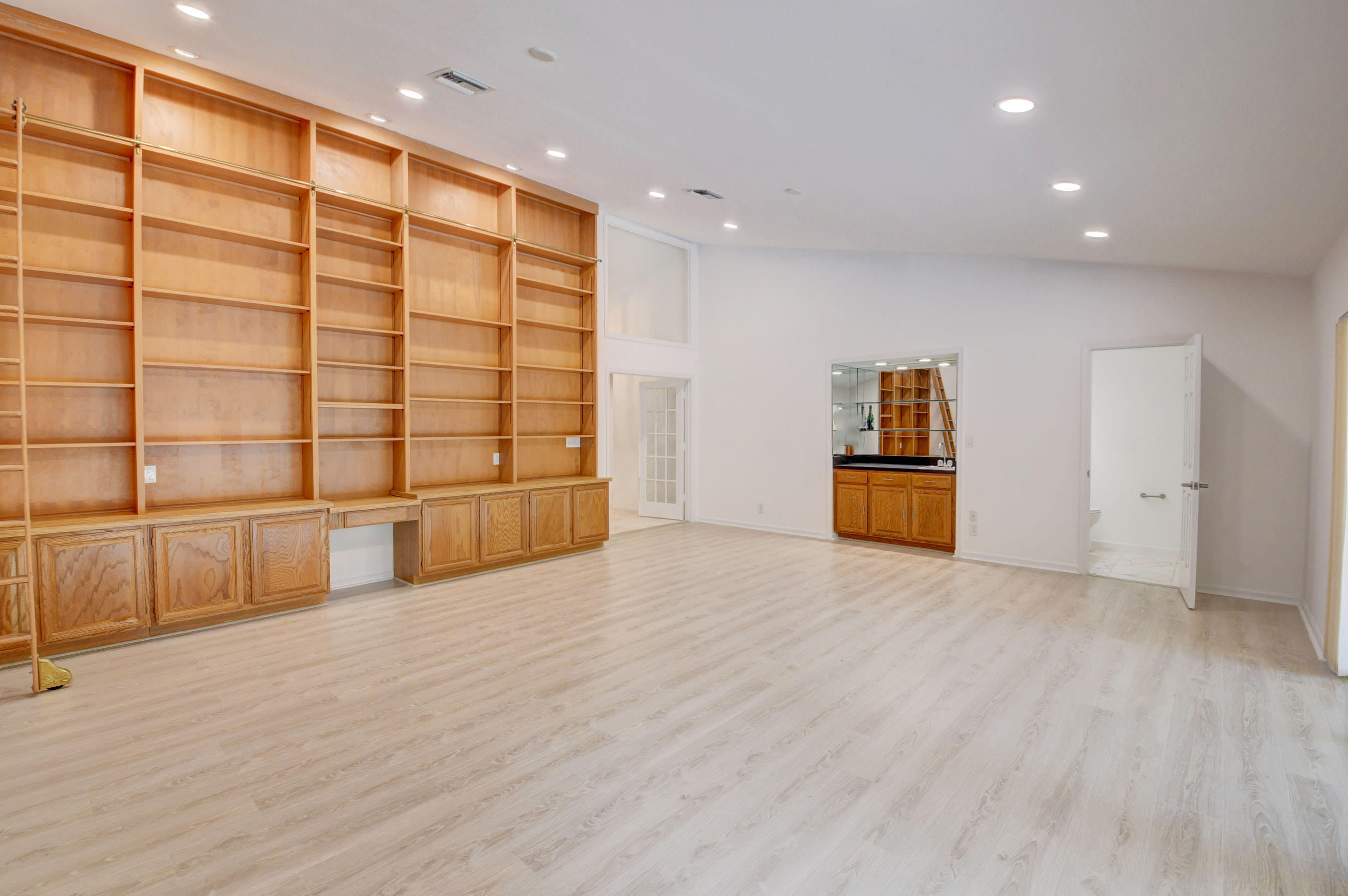 3230 St James Drive Boca Raton, FL 33434 - Photo 13 of 62 a view of an empty room with a cabinet and mirrors