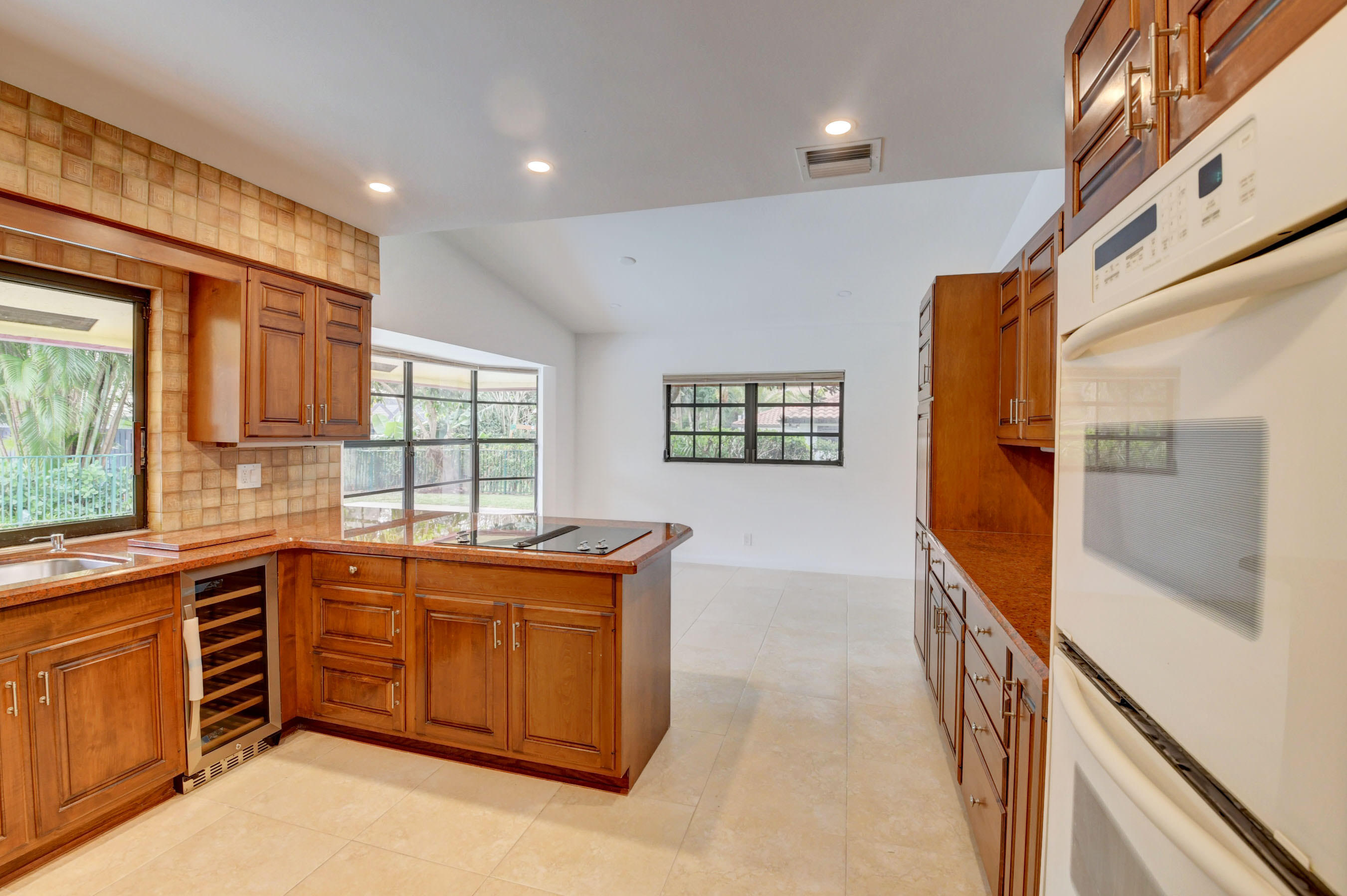 3230 St James Drive Boca Raton, FL 33434 - Photo 14 of 62 a hallway with a sink and cabinets