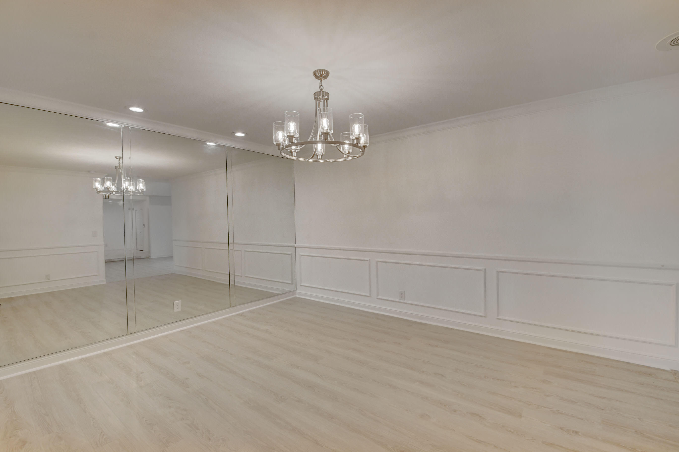 3230 St James Drive Boca Raton, FL 33434 - Photo 28 of 62 a view of an empty room with a chandelier fan