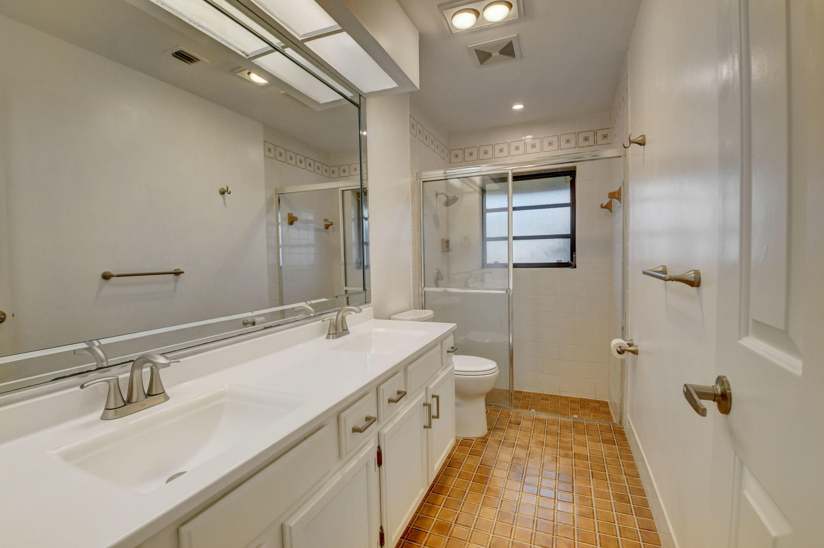 3230 St James Drive Boca Raton, FL 33434 - Photo 33 of 62 a spacious bathroom with a double vanity sink and mirror with shower
