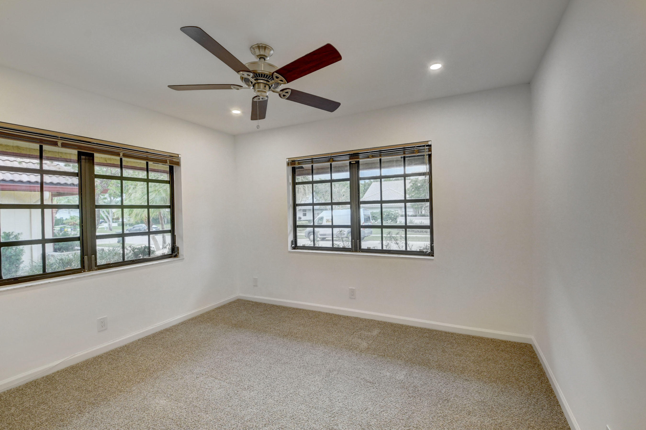 3230 St James Drive Boca Raton, FL 33434 - Photo 36 of 62 an empty room with windows and fan
