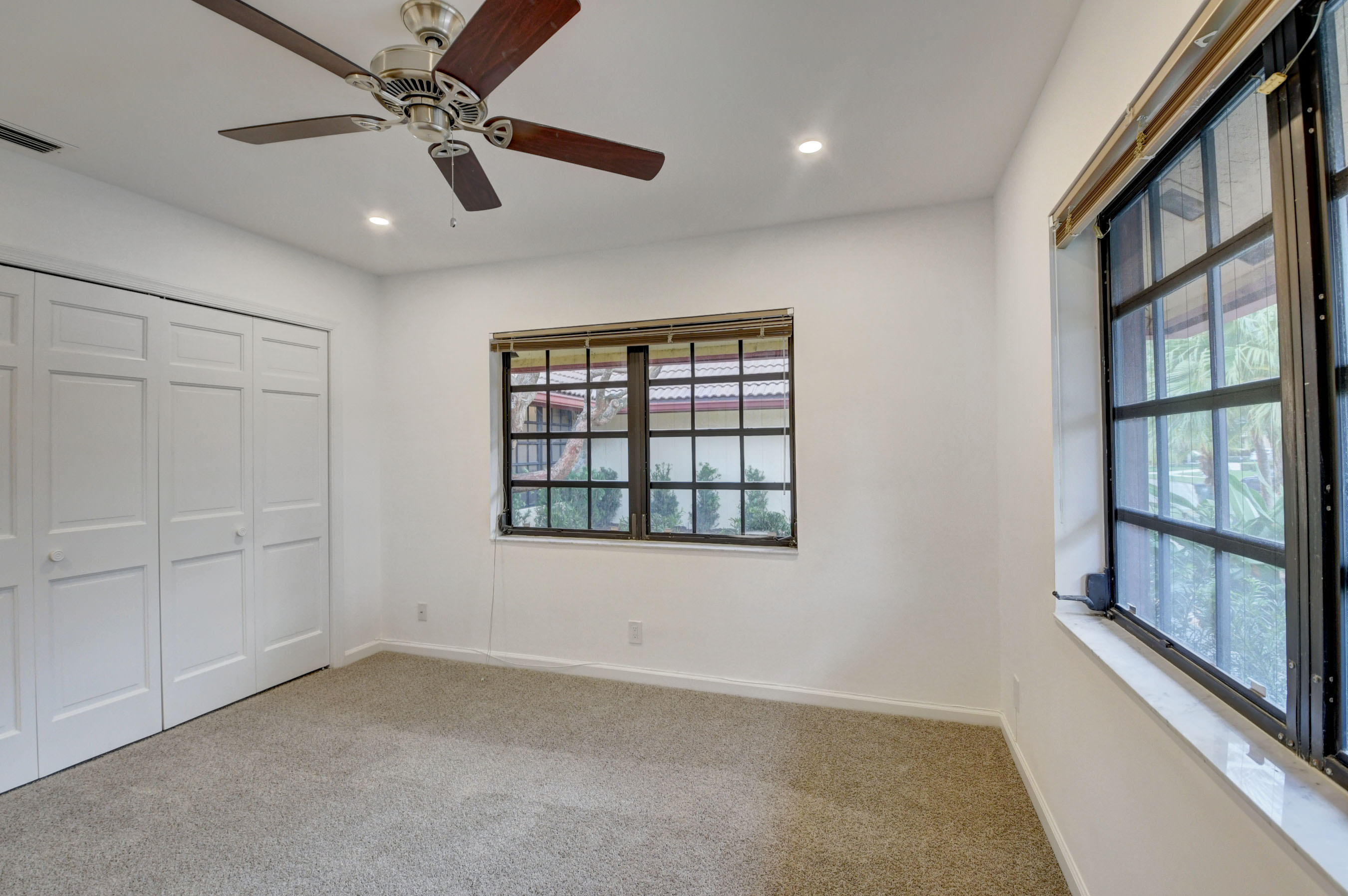 3230 St James Drive Boca Raton, FL 33434 - Photo 37 of 62 wooden floor in an empty room with a window