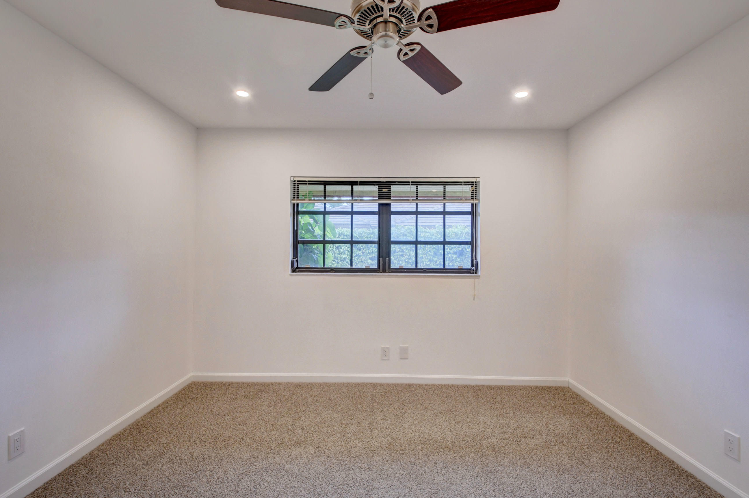 3230 St James Drive Boca Raton, FL 33434 - Photo 42 of 62 an empty room with a window and a ceiling fan