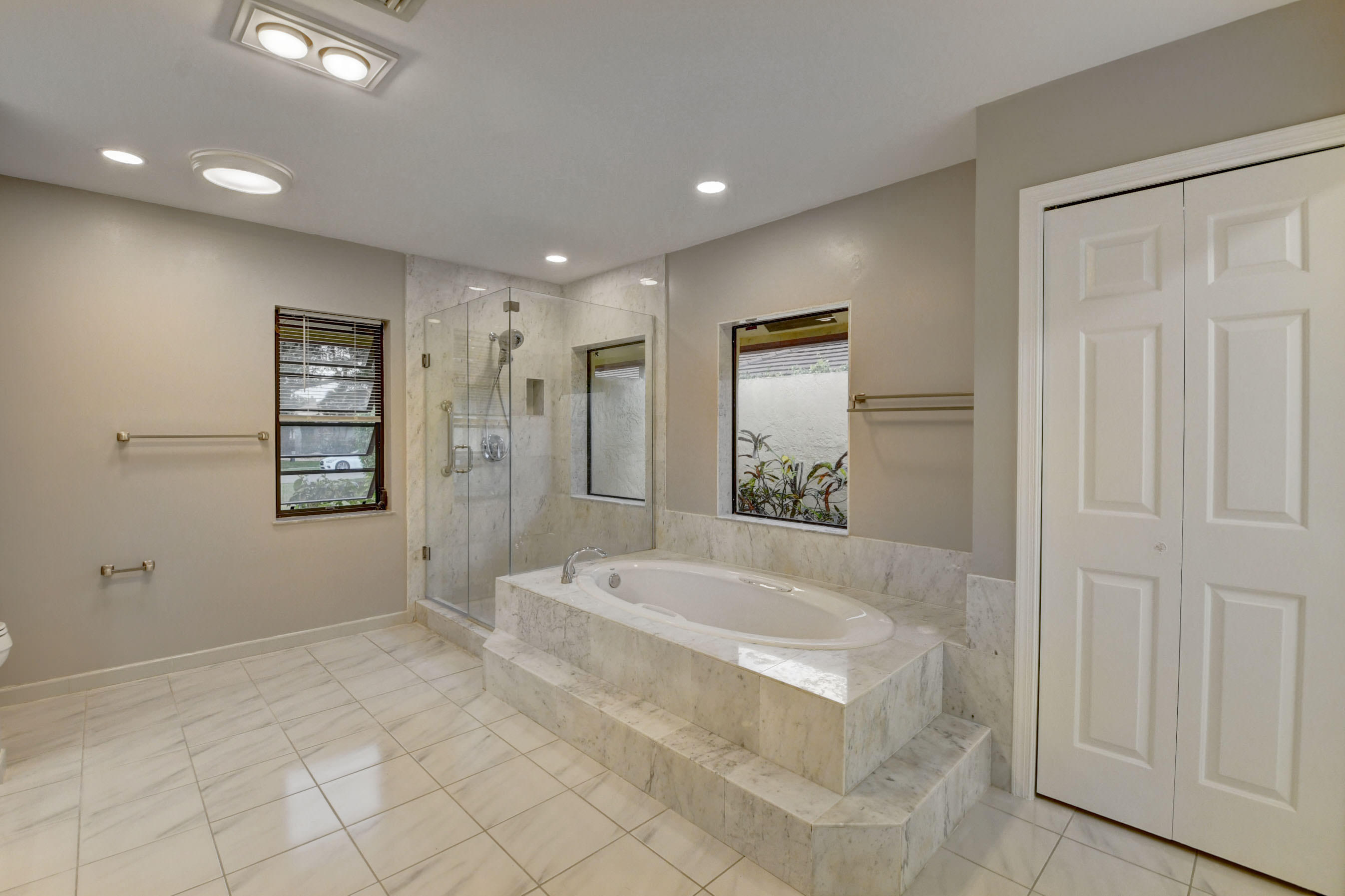 3230 St James Drive Boca Raton, FL 33434 - Photo 50 of 62 a spacious bathroom with a bathtub and shower