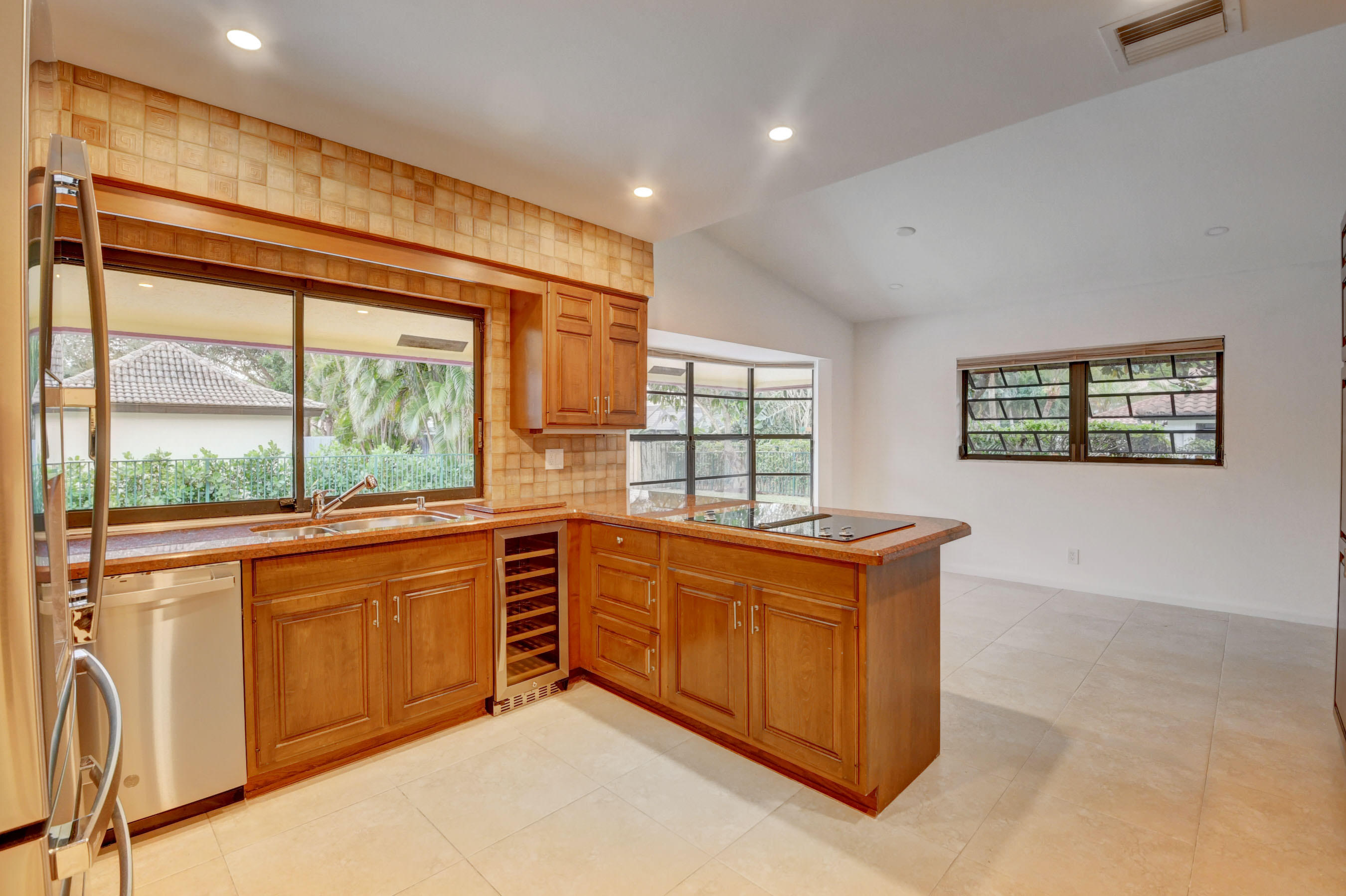 3230 St James Drive Boca Raton, FL 33434 - Photo 55 of 62 a kitchen with stainless steel appliances granite countertop a stove and a refrigerator