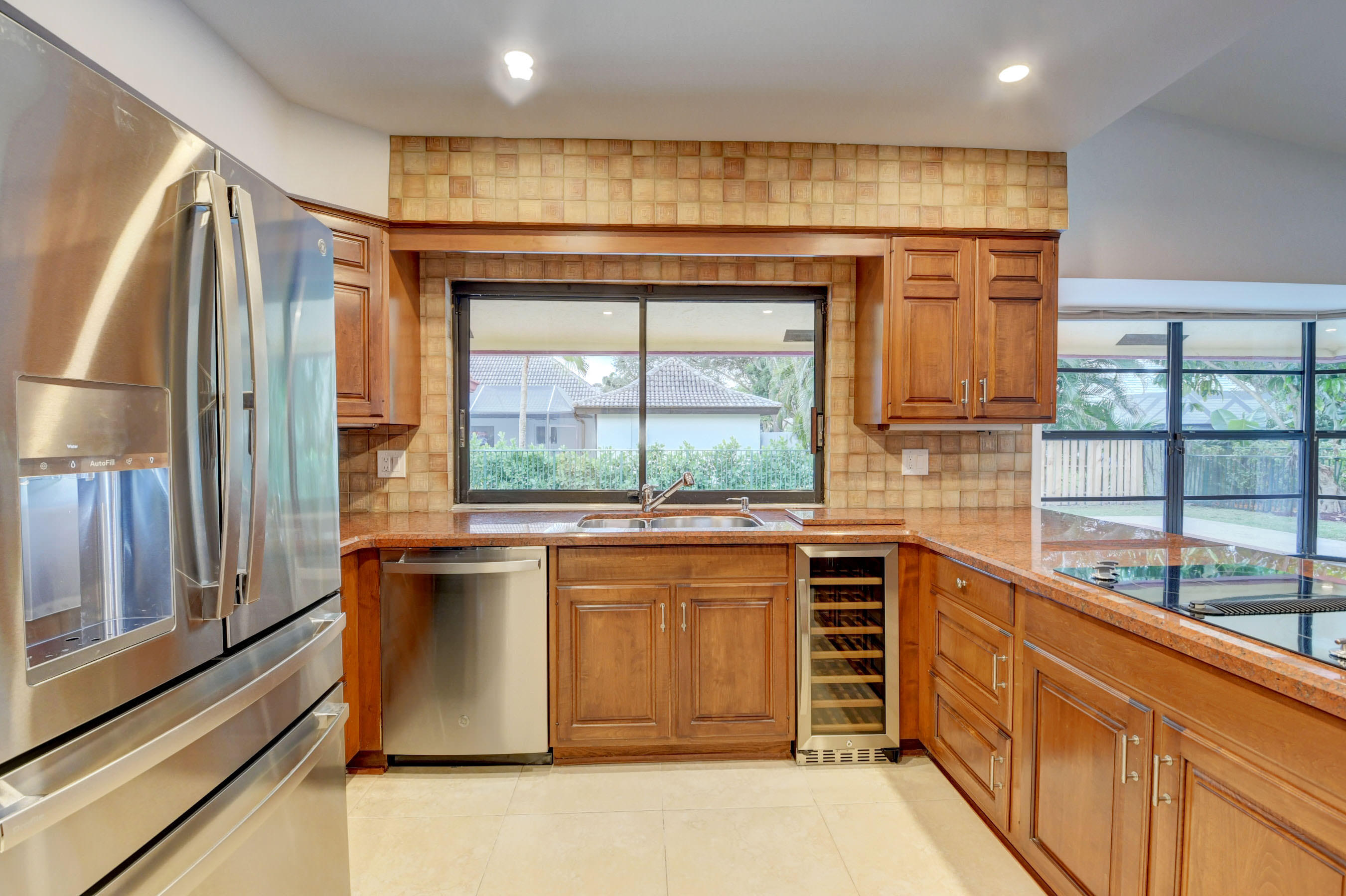 3230 St James Drive Boca Raton, FL 33434 - Photo 56 of 62 a kitchen with stainless steel appliances granite countertop a stove a sink and a refrigerator