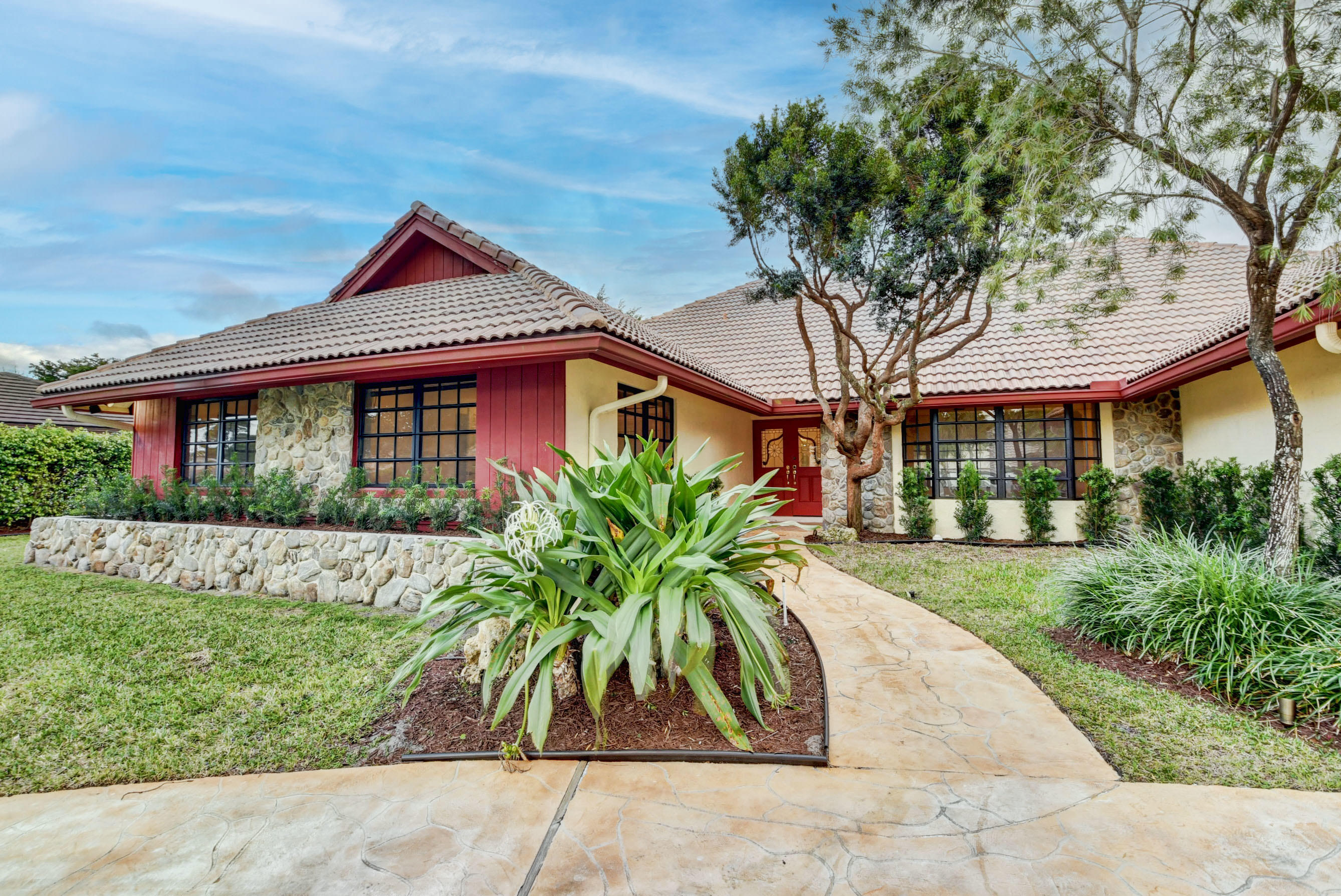 3230 St James Drive Boca Raton, FL 33434 - Photo 59 of 62 a front view of a house with garden