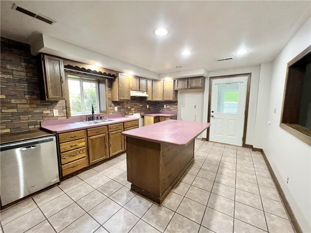 4293 Wampum Road New Castle, PA 16102 - Photo 8 of 16 a kitchen with a sink a counter top space stainless steel appliances and cabinets