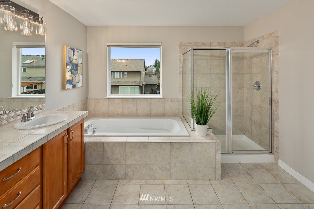 21809 39th Drive Southeast Bothell, WA 98021 - Photo 22 of 36 a bathroom with a bathtub a sink and a shower