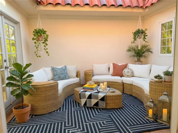 a living room with furniture and a potted plant