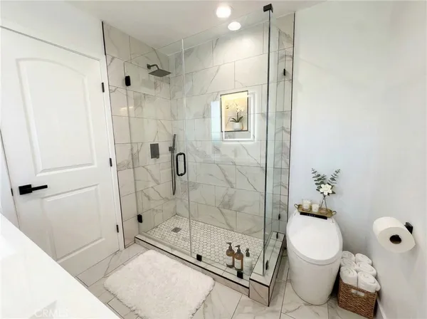 a bathroom with a shower a toilet and sink