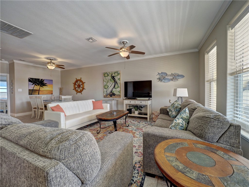 1833 Eleventh Street, Unit F2 Port Aransas, TX 78373 - Photo 13 of 40 a living room with furniture and a flat screen tv