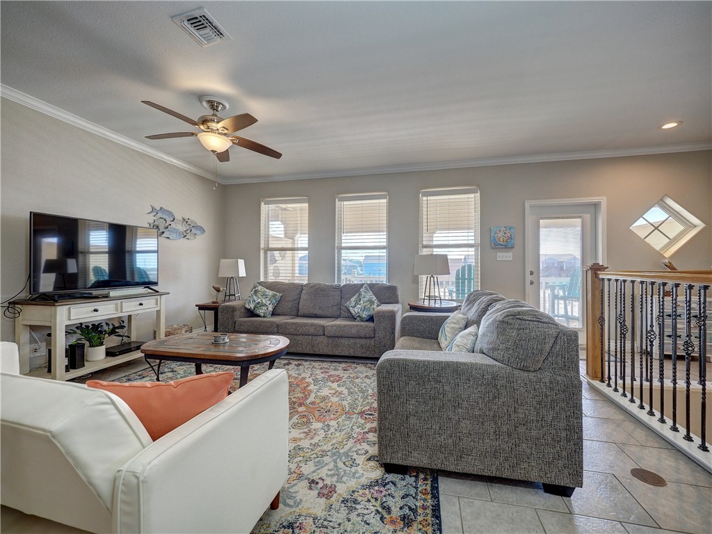 1833 Eleventh Street, Unit F2 Port Aransas, TX 78373 - Photo 14 of 40 a living room with furniture and a flat screen tv