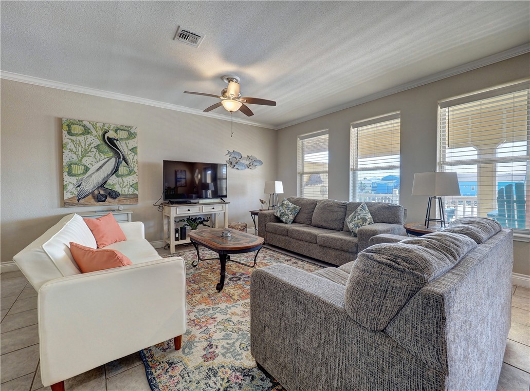 1833 Eleventh Street, Unit F2 Port Aransas, TX 78373 - Photo 15 of 40 a living room with furniture a large window and a flat screen tv