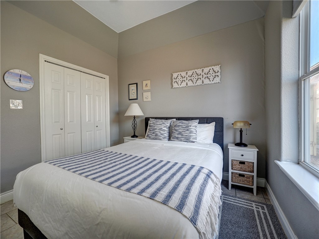 1833 Eleventh Street, Unit F2 Port Aransas, TX 78373 - Photo 22 of 40 a bedroom with a bed and a window