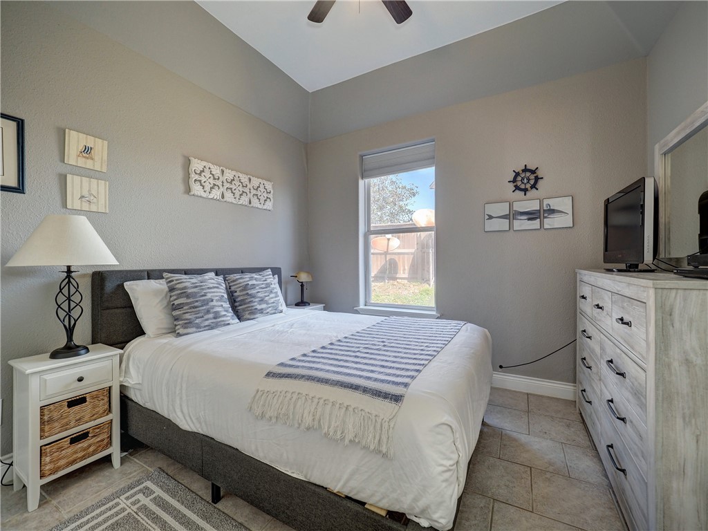 1833 Eleventh Street, Unit F2 Port Aransas, TX 78373 - Photo 23 of 40 a bedroom with a bed and a window