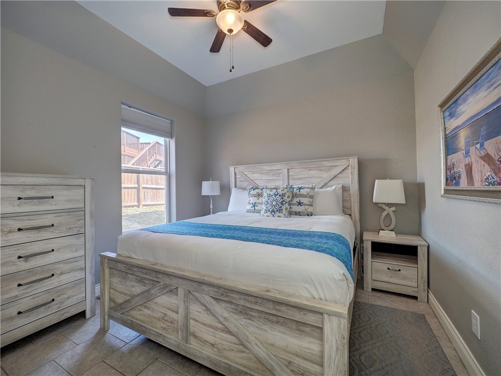 1833 Eleventh Street, Unit F2 Port Aransas, TX 78373 - Photo 25 of 40 a bedroom with a bed and a window