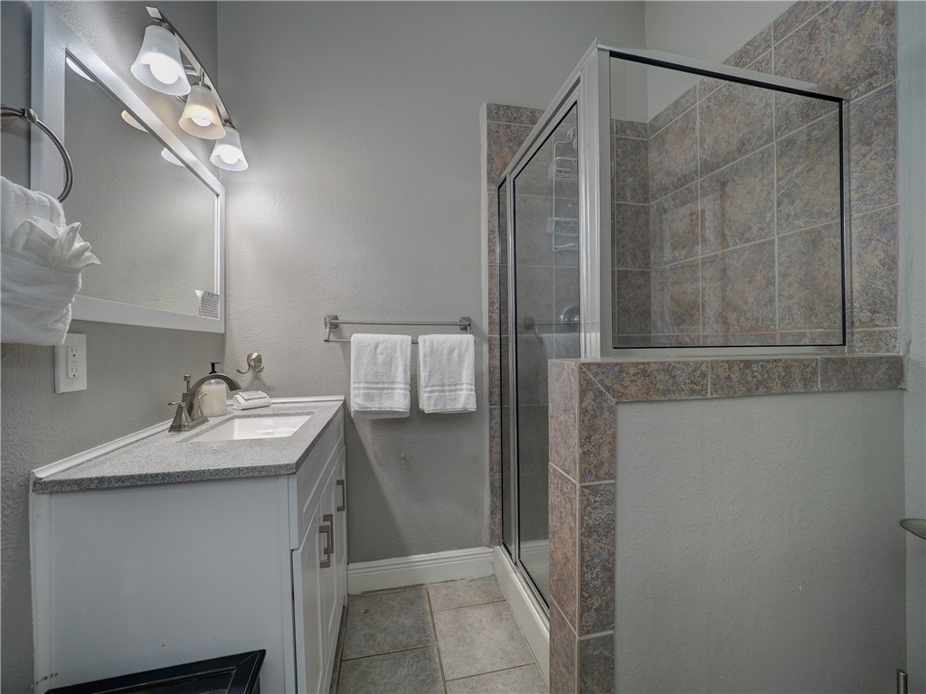 1833 Eleventh Street, Unit F2 Port Aransas, TX 78373 - Photo 26 of 40 a bathroom with a sink and mirror