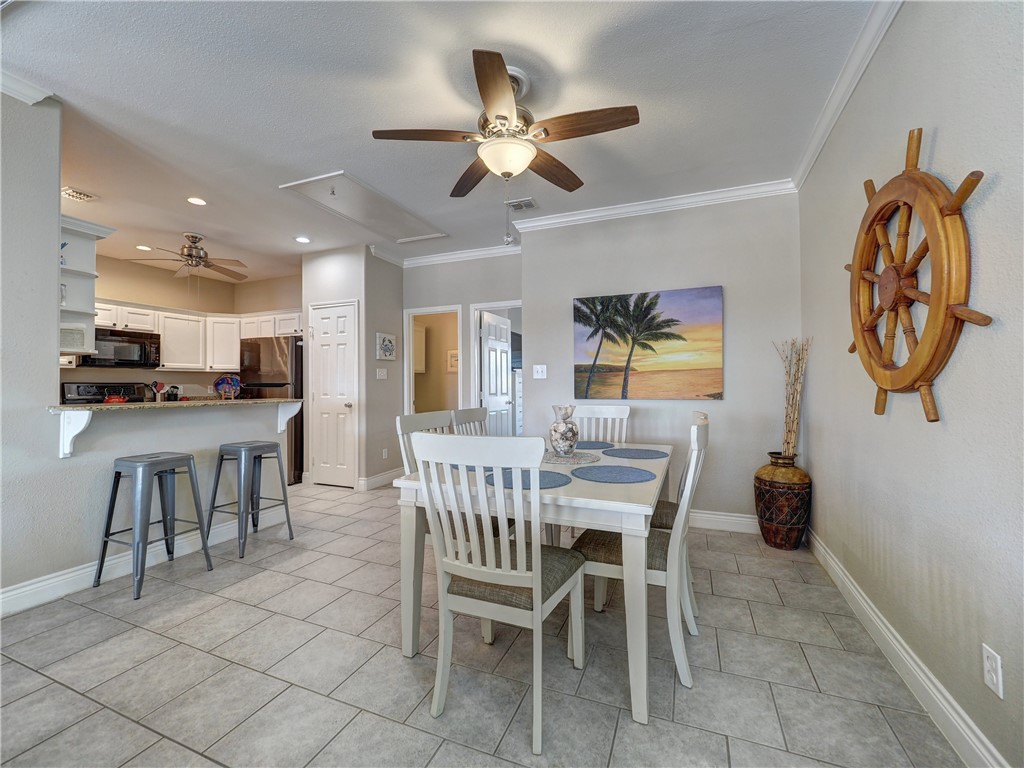 1833 Eleventh Street, Unit F2 Port Aransas, TX 78373 - Photo 7 of 40 a dining room with furniture and window