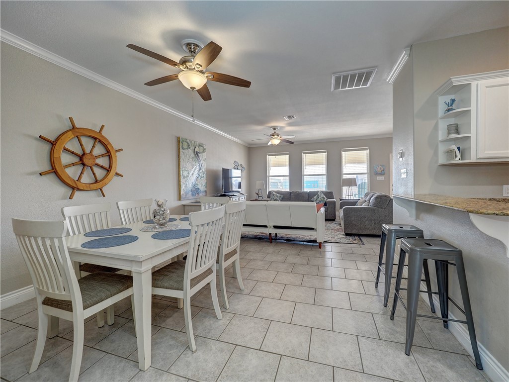 1833 Eleventh Street, Unit F2 Port Aransas, TX 78373 - Photo 10 of 40 a view of a dining room and hall with furniture