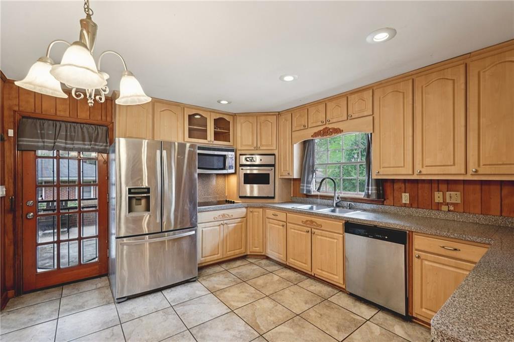 3407 West Manor Lane Southwest Atlanta, GA 30311 - Photo 12 of 36 a kitchen with stainless steel appliances granite countertop a refrigerator sink and cabinets