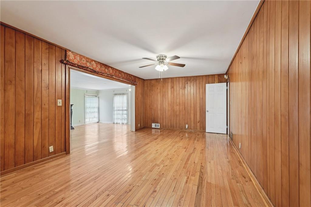 3407 West Manor Lane Southwest Atlanta, GA 30311 - Photo 17 of 36 wooden floor in an empty room with a window