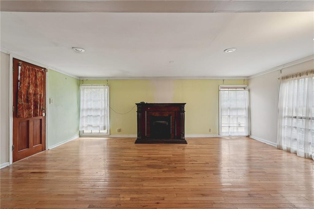 3407 West Manor Lane Southwest Atlanta, GA 30311 - Photo 19 of 36 a view of an empty room with wooden floor and a window