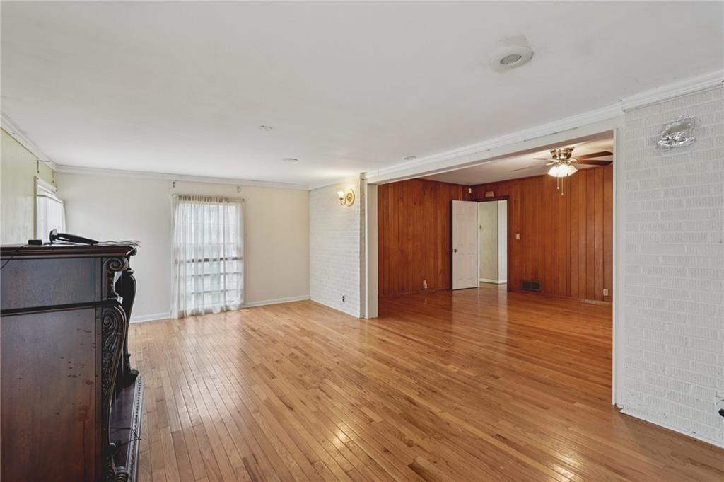 3407 West Manor Lane Southwest Atlanta, GA 30311 - Photo 20 of 36 a view of an empty room with wooden floor and a window