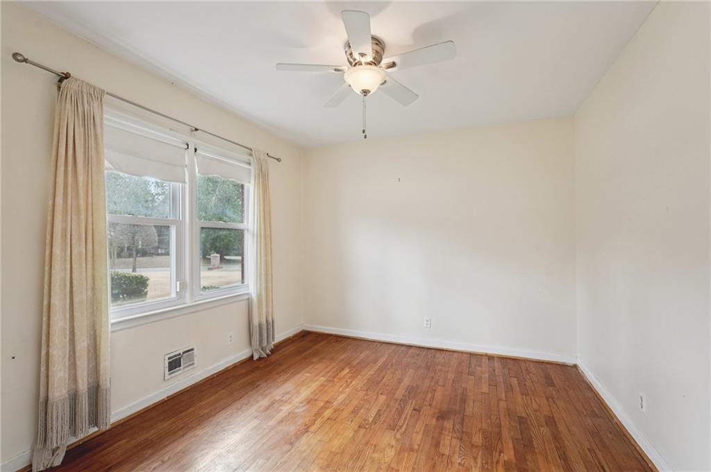 3407 West Manor Lane Southwest Atlanta, GA 30311 - Photo 21 of 36 wooden floor in an empty room with a window