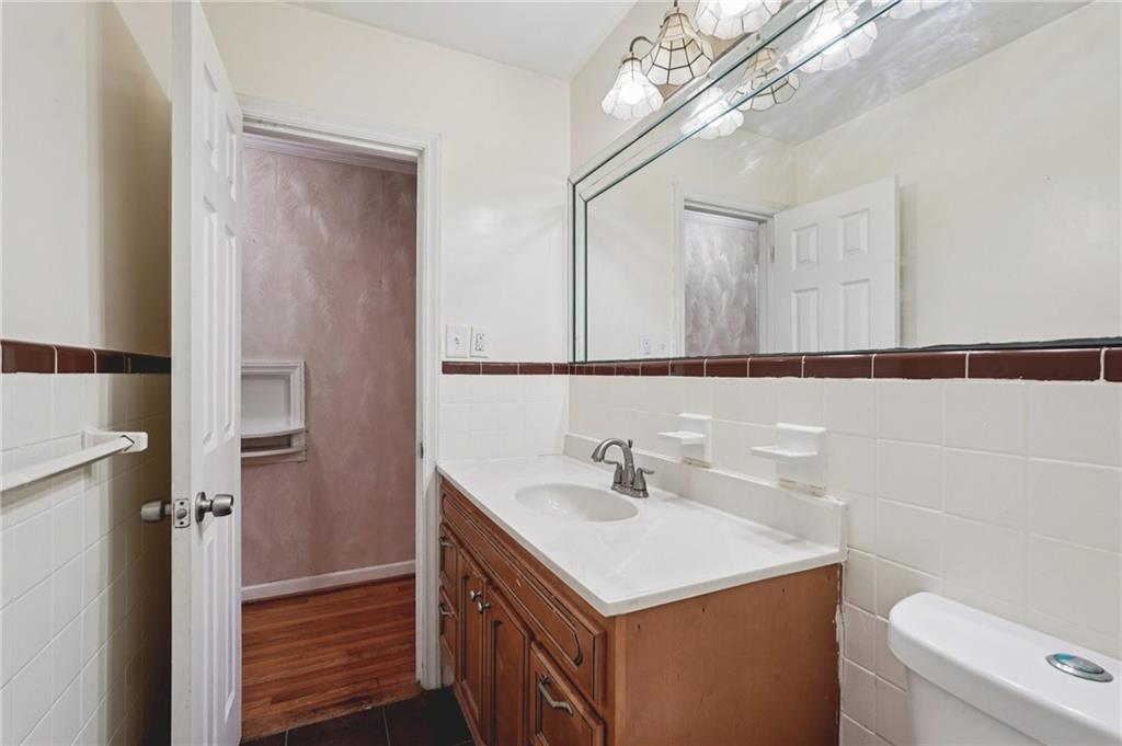 3407 West Manor Lane Southwest Atlanta, GA 30311 - Photo 23 of 36 a bathroom with a sink a toilet and a mirror