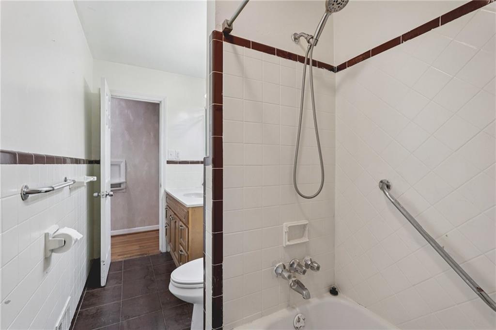 3407 West Manor Lane Southwest Atlanta, GA 30311 - Photo 24 of 36 a bathroom with a shower a toilet and a shower