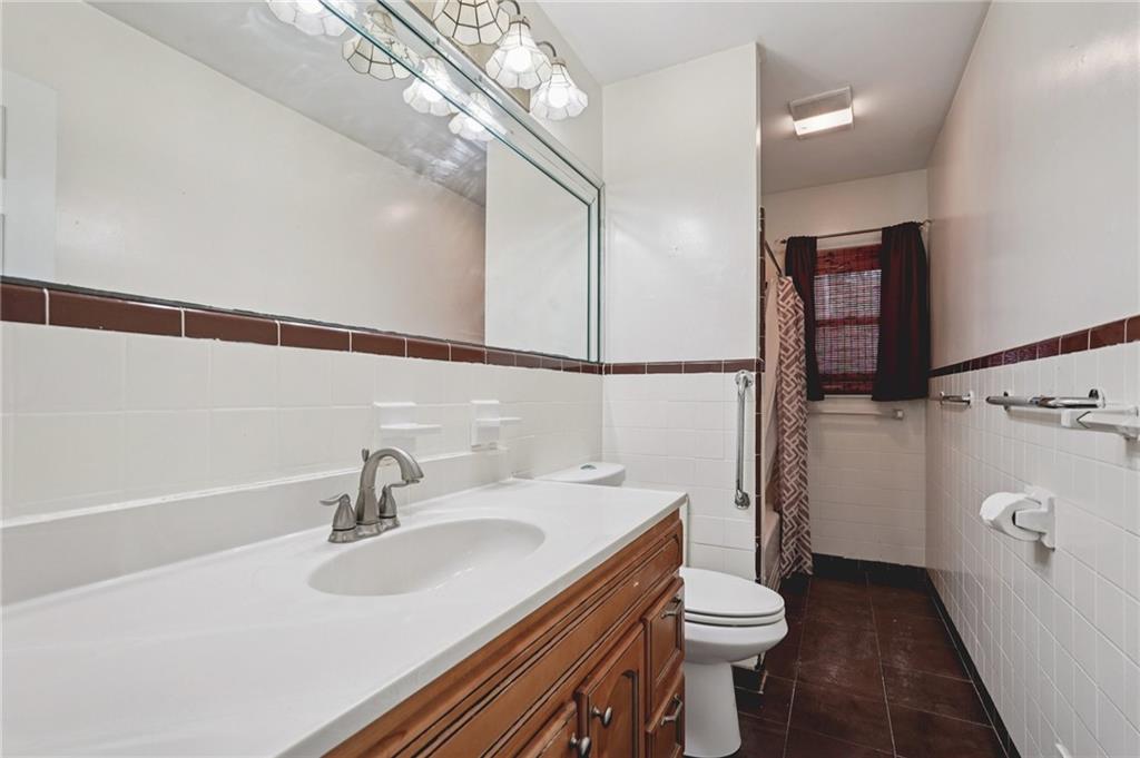 3407 West Manor Lane Southwest Atlanta, GA 30311 - Photo 25 of 36 a bathroom with a sink a toilet and shower