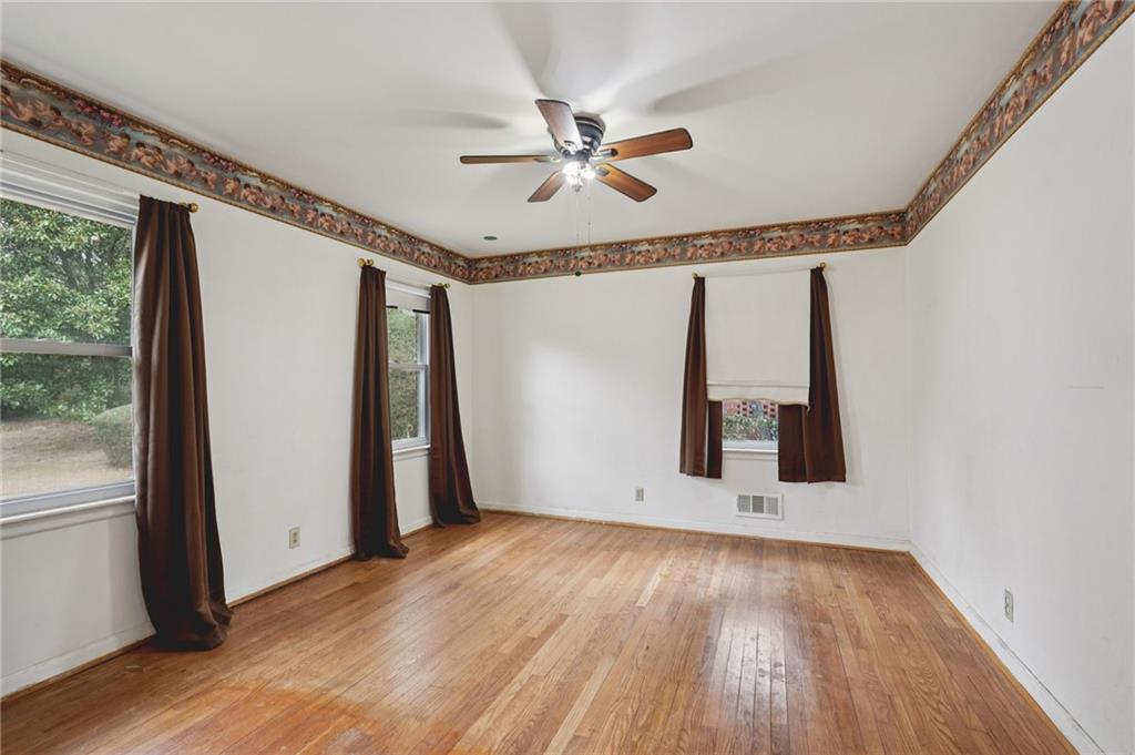 3407 West Manor Lane Southwest Atlanta, GA 30311 - Photo 28 of 36 a view of an empty room with wooden floor and a window
