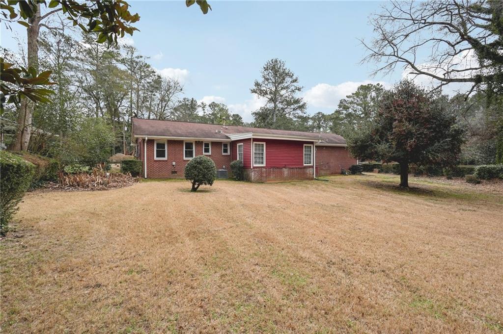 3407 West Manor Lane Southwest Atlanta, GA 30311 - Photo 34 of 36 a front view of a house with a yard and trees