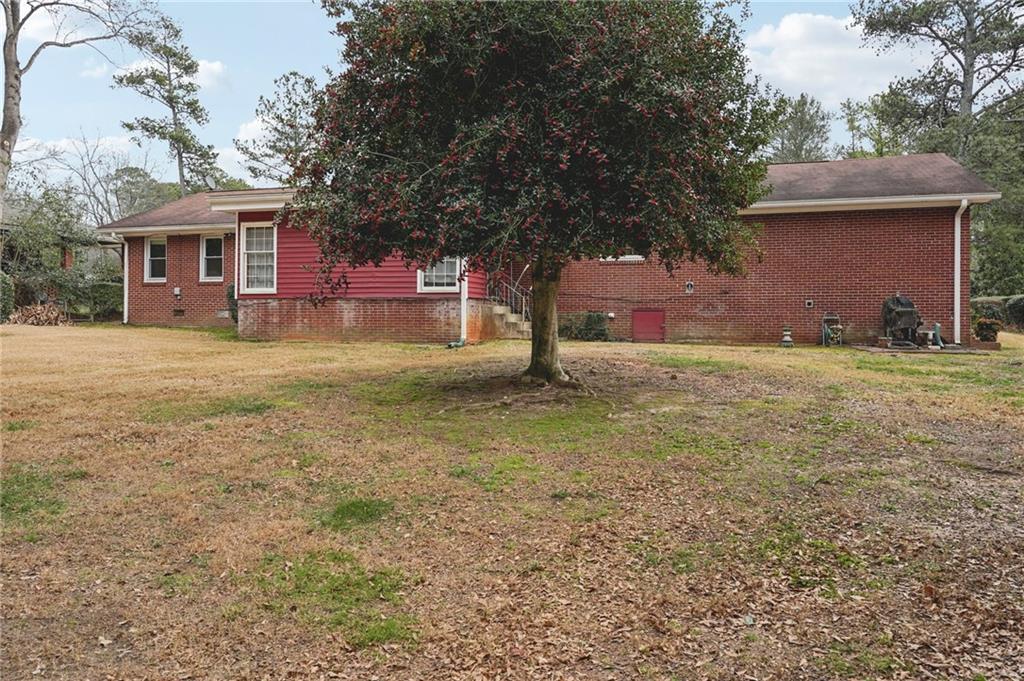 3407 West Manor Lane Southwest Atlanta, GA 30311 - Photo 35 of 36 a view of a yard in front of a house with large trees