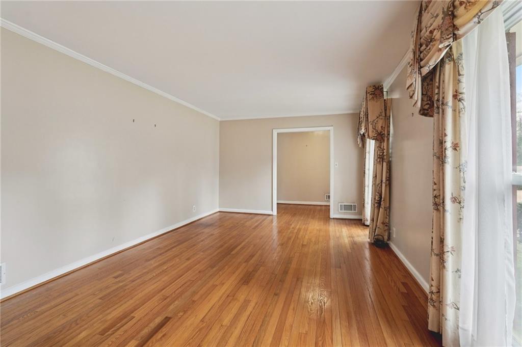 3407 West Manor Lane Southwest Atlanta, GA 30311 - Photo 8 of 36 a view of a hallway with wooden floor and brick walls