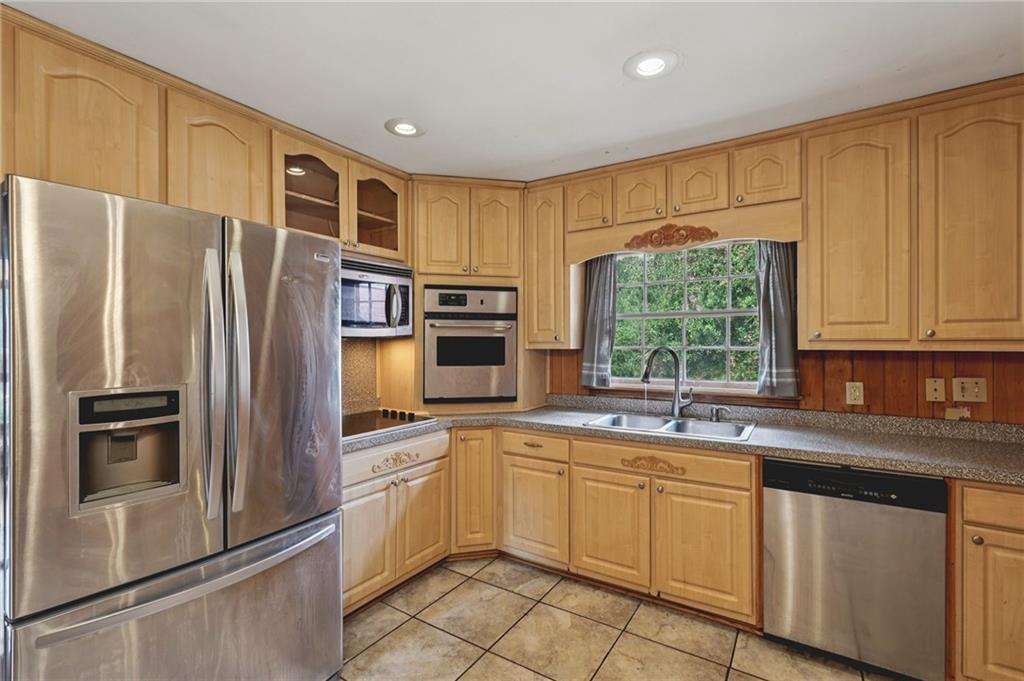 3407 West Manor Lane Southwest Atlanta, GA 30311 - Photo 10 of 36 a kitchen with stainless steel appliances a refrigerator sink and microwave