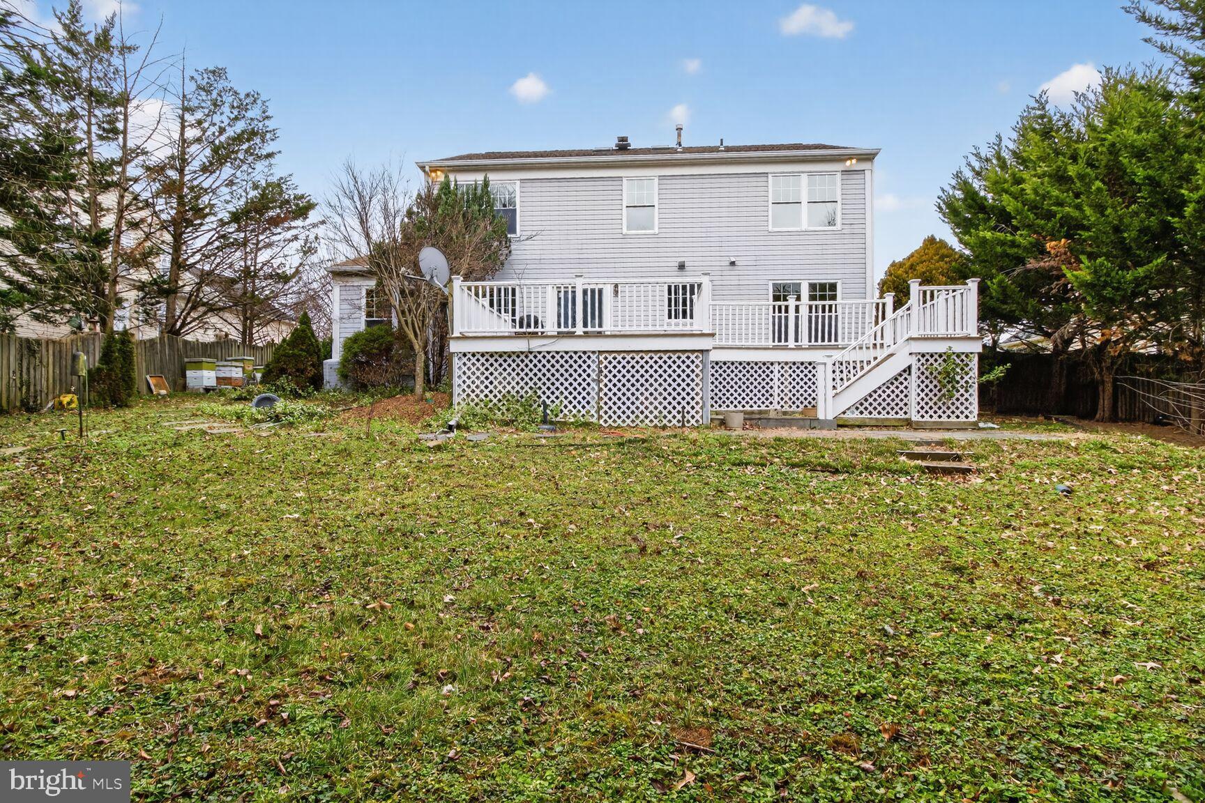 64 Foxwell Bend Road Glen Burnie, MD 21061 - Photo 33 of 38 Spacious backyard with deck and greenery.