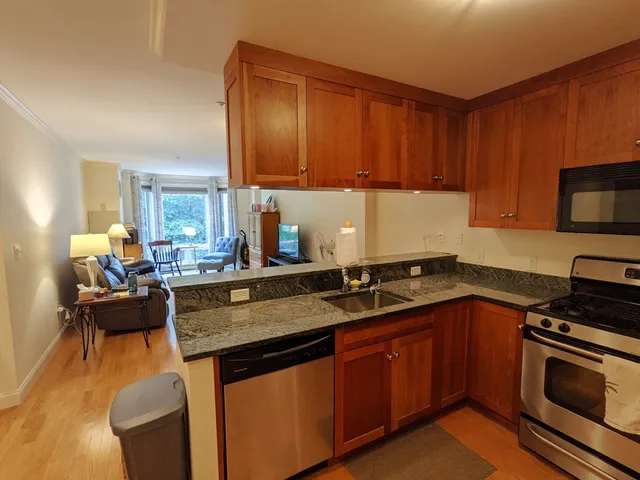 a kitchen with a sink stove and cabinets