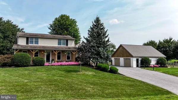 a front view of house with yard and green space
