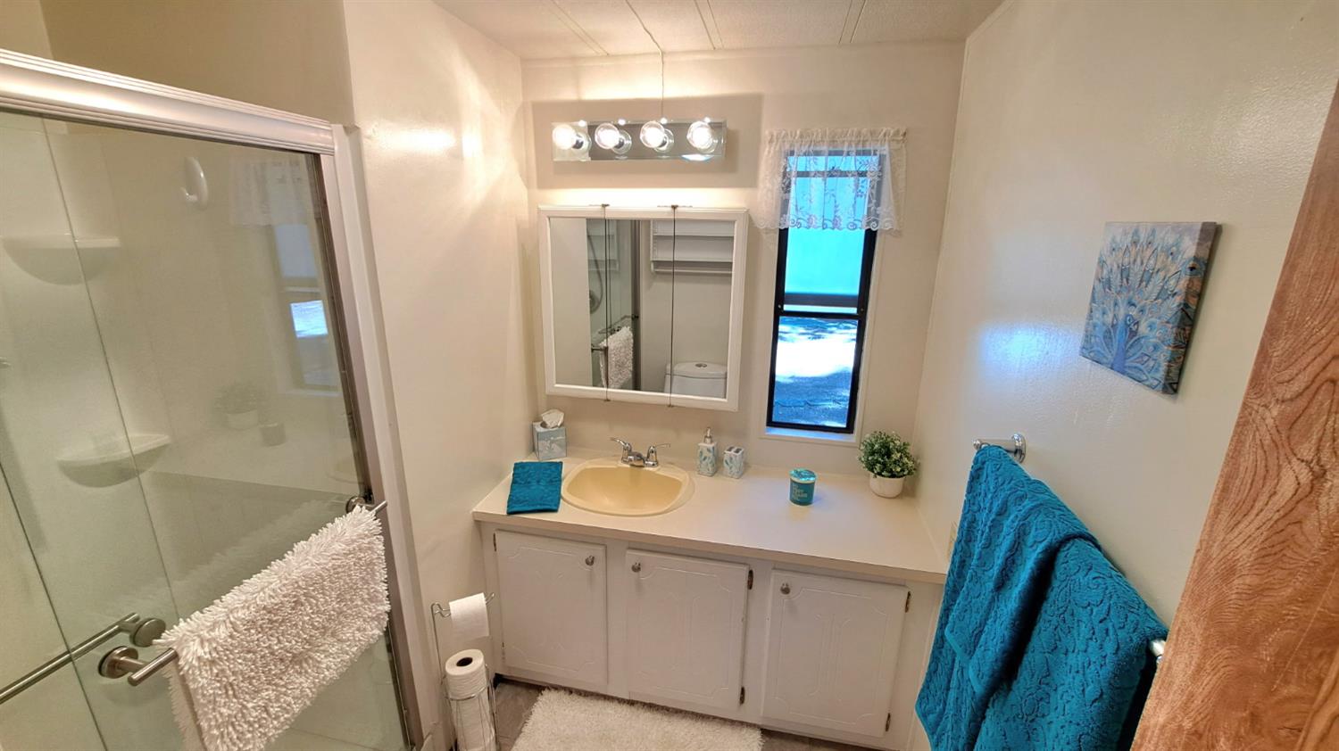 5766 Pony Express Trail, Unit 4 Pollock Pines, CA 95726 - Photo 13 of 17 a bathroom with a sink and a mirror