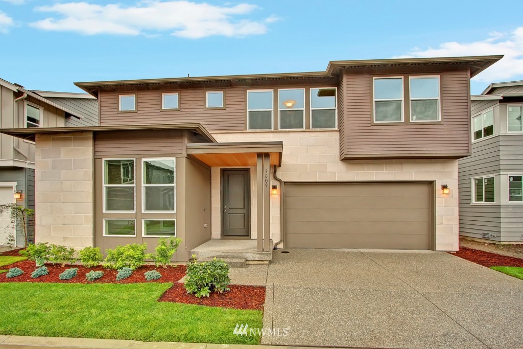 3609 177th Place Southeast, Unit 1015 Bothell, WA 98012 - Photo 1 of 14 a front view of a house with a garden and plants