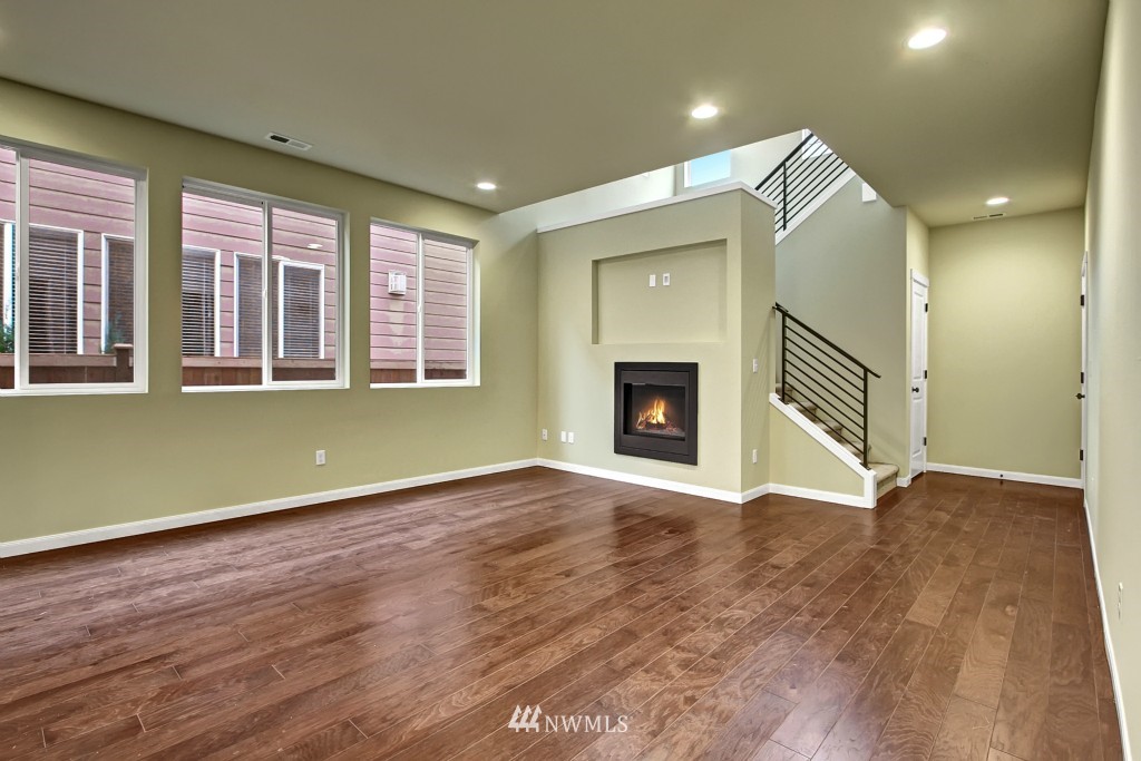 3609 177th Place Southeast, Unit 1015 Bothell, WA 98012 - Photo 4 of 14 a view of an empty room with a fireplace and a window
