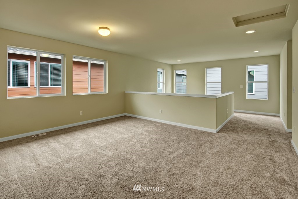 3609 177th Place Southeast, Unit 1015 Bothell, WA 98012 - Photo 5 of 14 an empty room with a window and chandelier