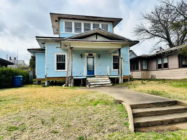 a front view of a house with swimming pool and porch