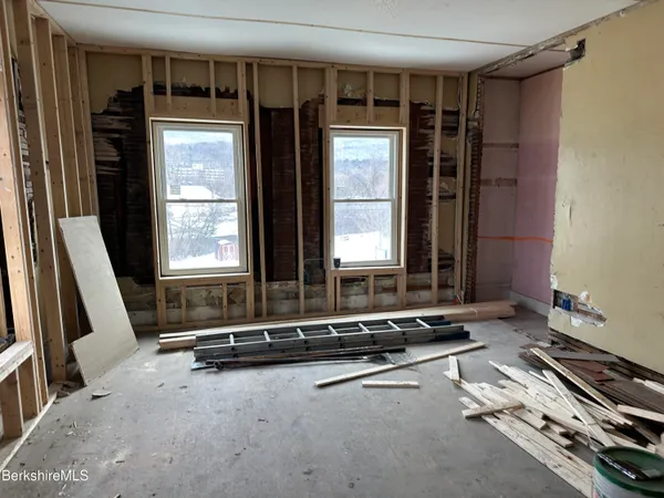 a room with gym equipment and large mirror