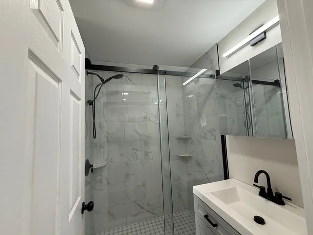 a bathroom with a shower and sink