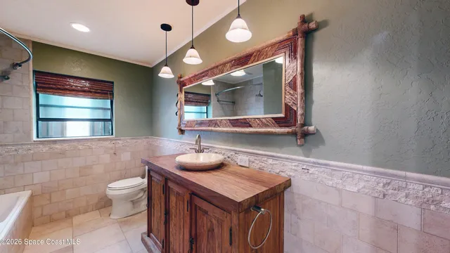 a view of hallway with a window and wooden floor