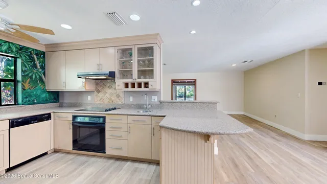 a view of kitchen with a refrigerator and a stove
